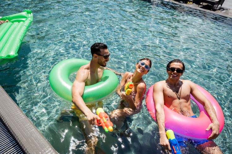 Photo Of People In Pool With Floaties