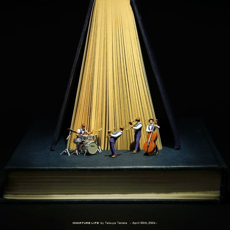 Miniature depicting musicians playing under the limelight made out of a book