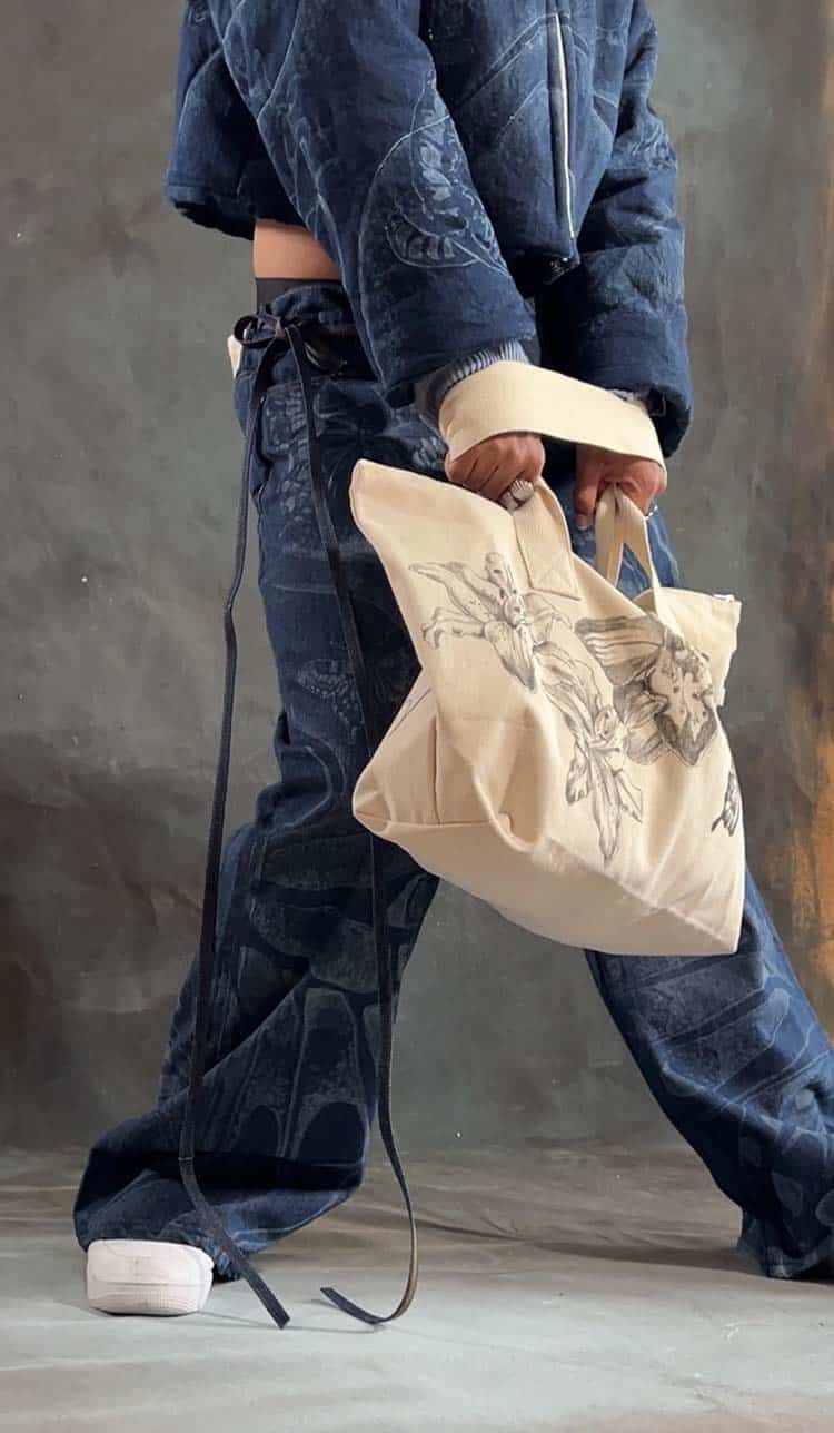  A close up shot of Emily Starobrat's artwork on artisanal denim and tote bag