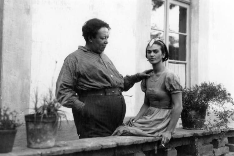 Diego Rivera and Frida Kahlo sitting on a terrace