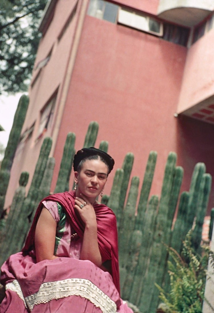 Frida Kahlo sitting in front of cactus by Nickolas Muray