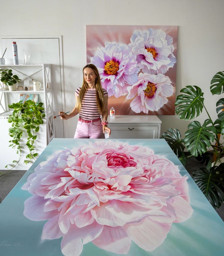 Artist Ira Volkova Standing Above Her Detailed Painting Of A Pink Peony
