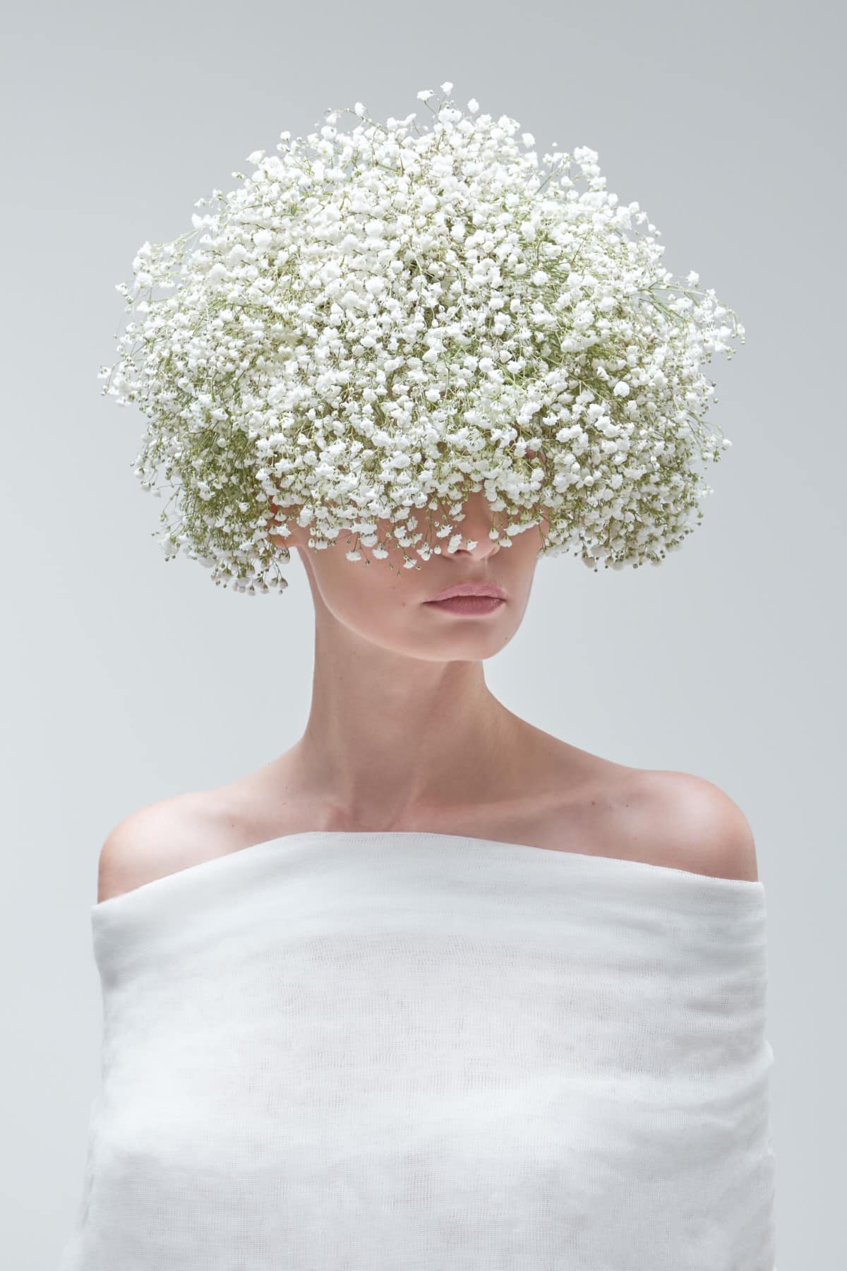 Woman with flower crown covering her eyes