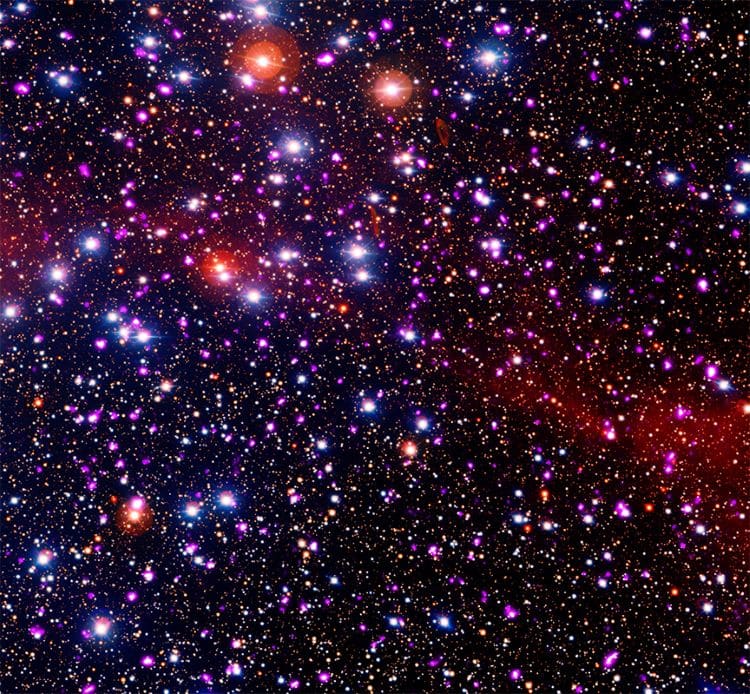 Cluster Of Stars In Space With Red, Blue, And Purple Stars