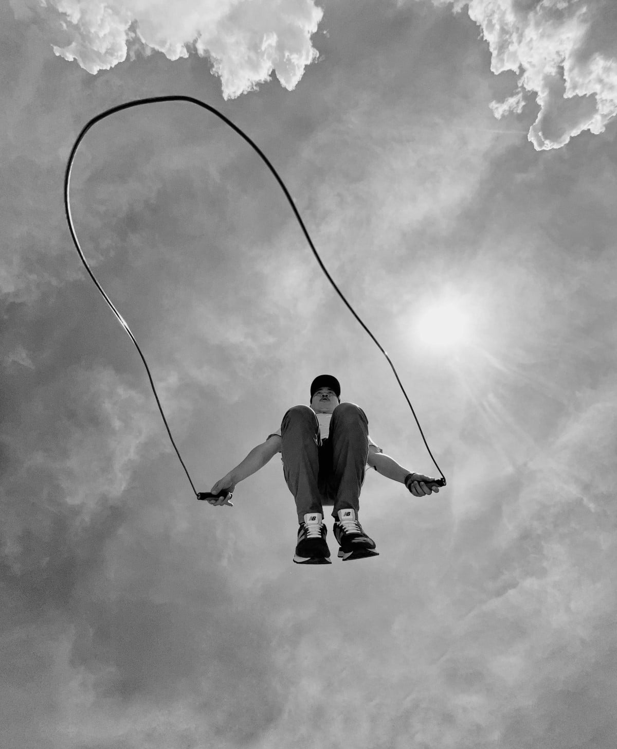 Image of a man jump roping as seen from below