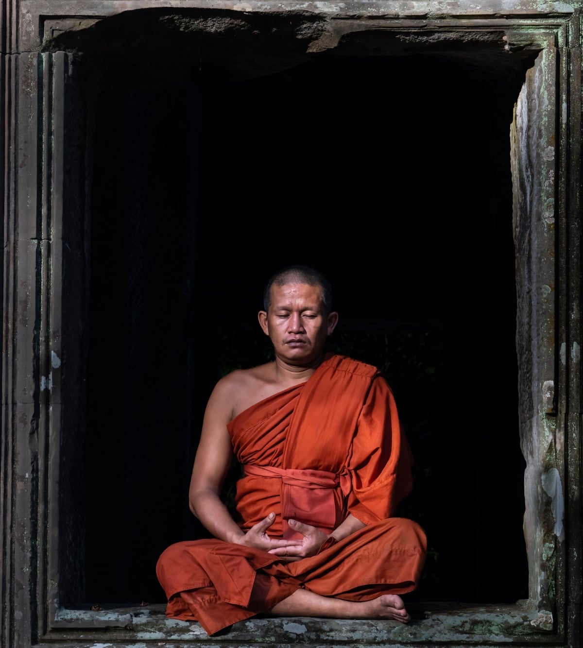 Buddhist monk meditating at Angkor Wat, Siem Riep, Cambodia