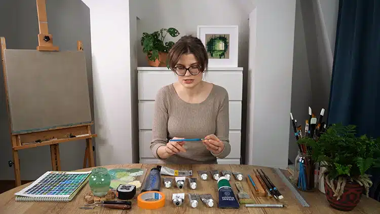 Luiza Niechoda looks at her materials laid out for her acrylic painting class