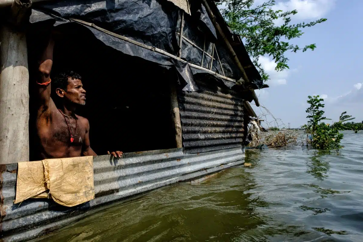 Flood victim in the Bay of Bengal looking outside his home