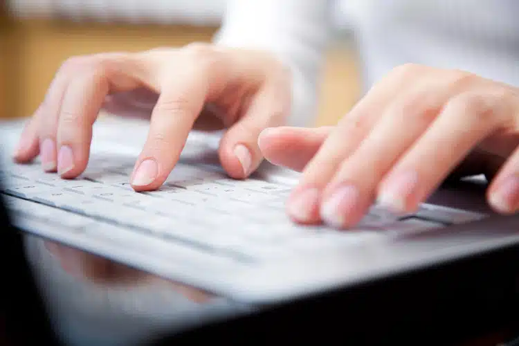 Woman typing on computer