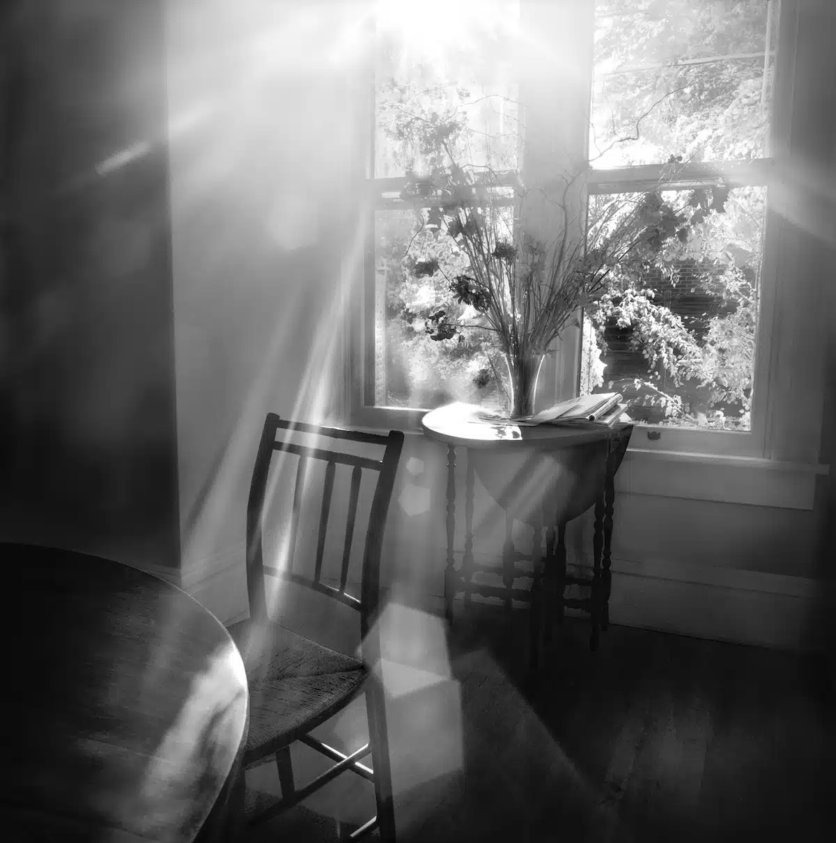 Black and white interior with light streaming through a window