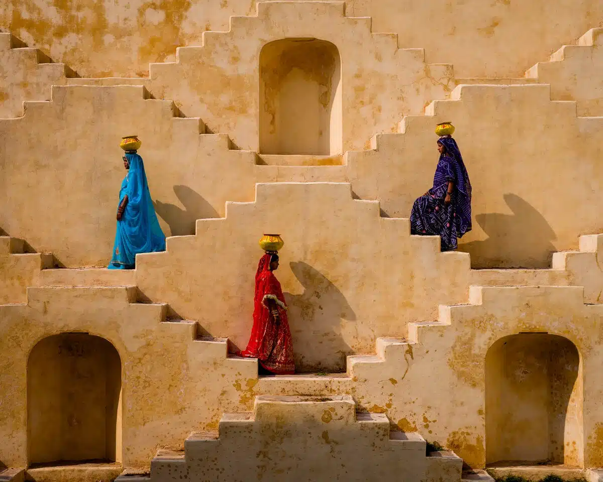 Women carrying baskets on their heads on the stepwells of Rajasthan