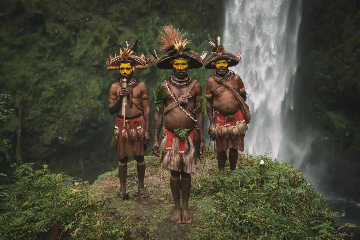 Portrait of the Huli Wigmen of Papua New Guinea in front of a waterfall