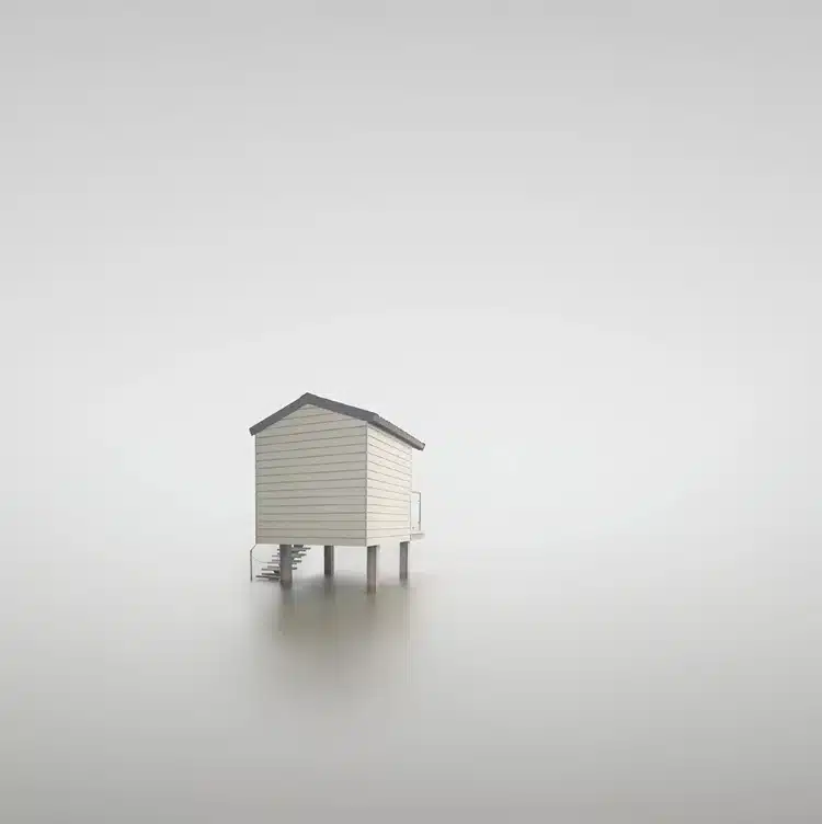 Long exposure image of beach hut over the water