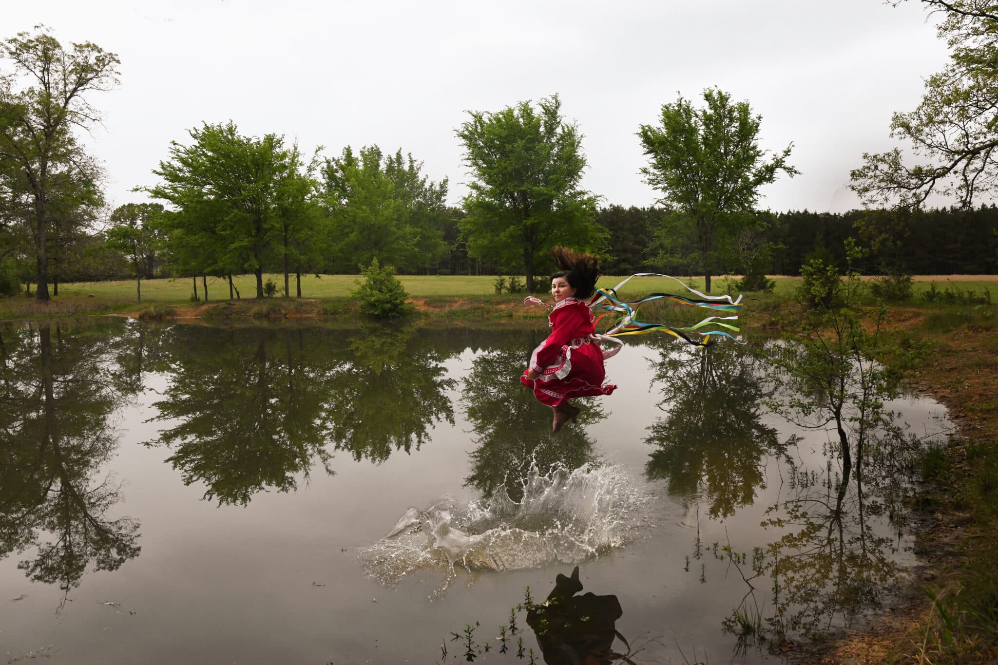 Choctaw woman jumping into a pond