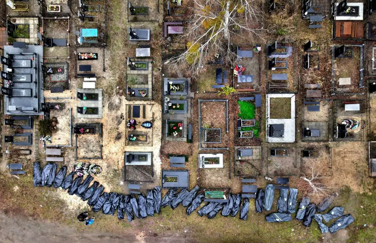 Body bags of people recovered from a mass grave are lined up at a cemetery as investigators begin the grim task of assessing evidence of war crimes in Bucha, Ukraine on April 9, 2022.