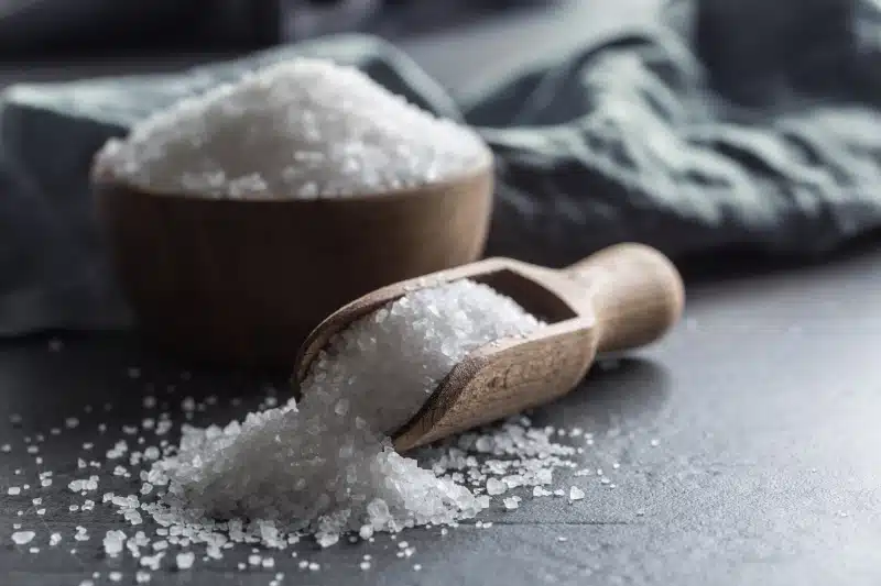 Crystaline sea salt in bowl and spoon - closeup.