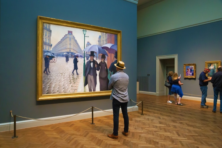 Man staring at Gustave Caillebotte painting 