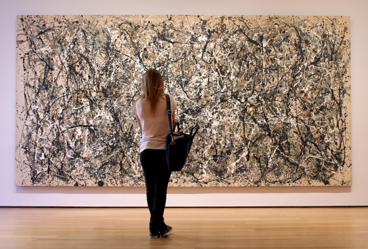 Woman looking at Jackson Pollock painting