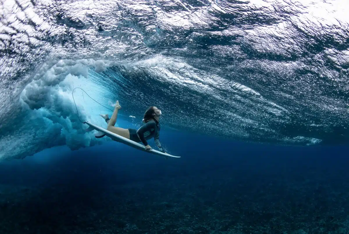 Olivia Ottaway dives under a towering wave in the waters of Teahupo'o, French Polynesia