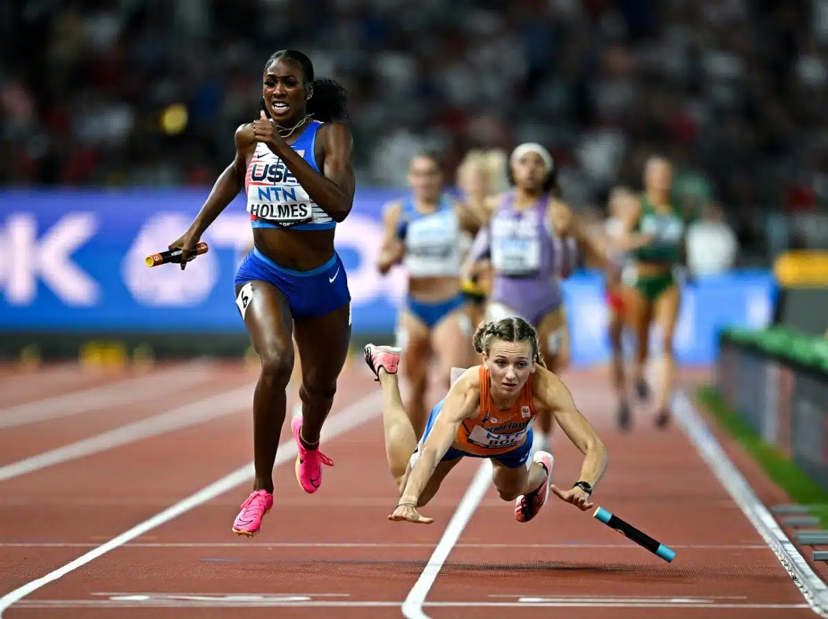 Femke Bol falling while Alexis Holmes of the USA sprints to victory in the 4x400m mixed relay at the 2024 Summer Olympics