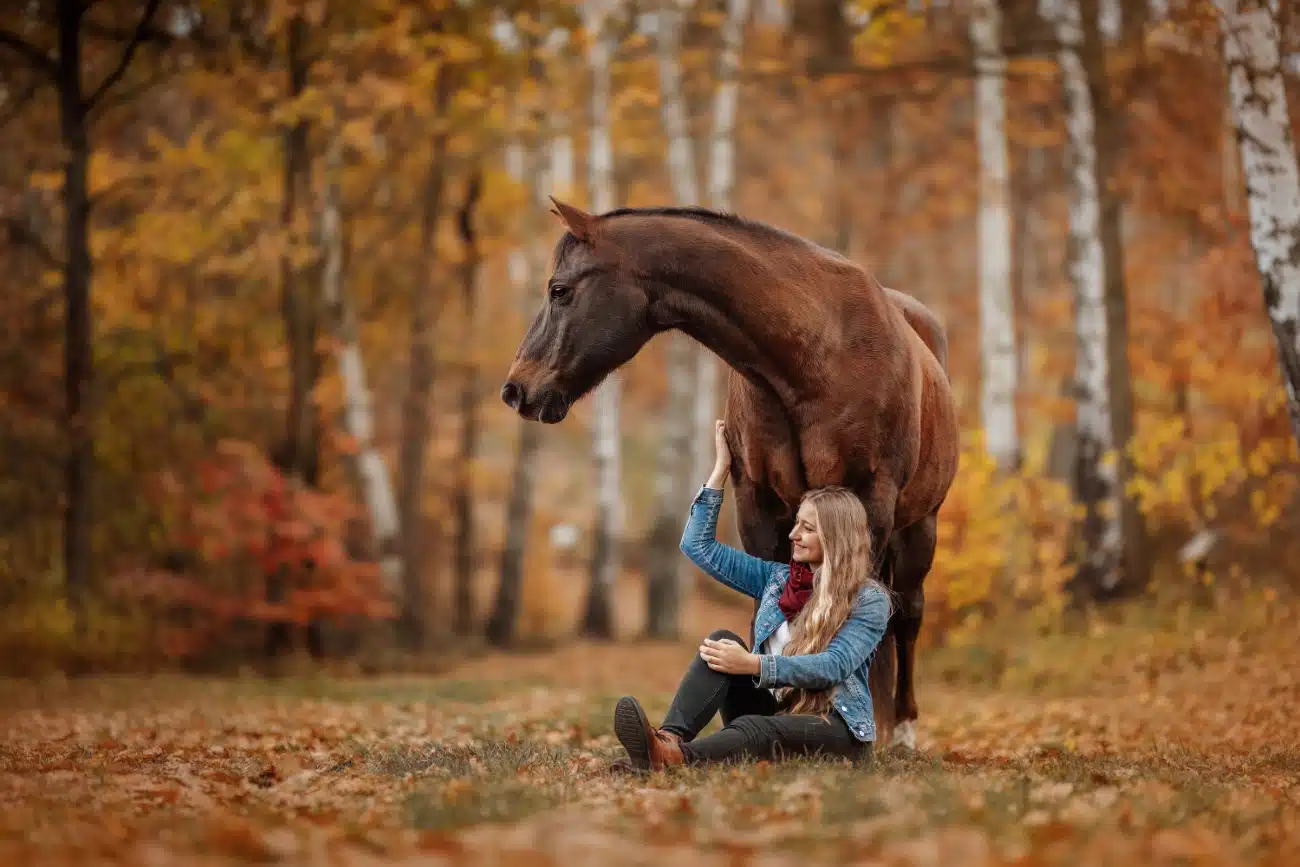 Woman and her horse in the forest