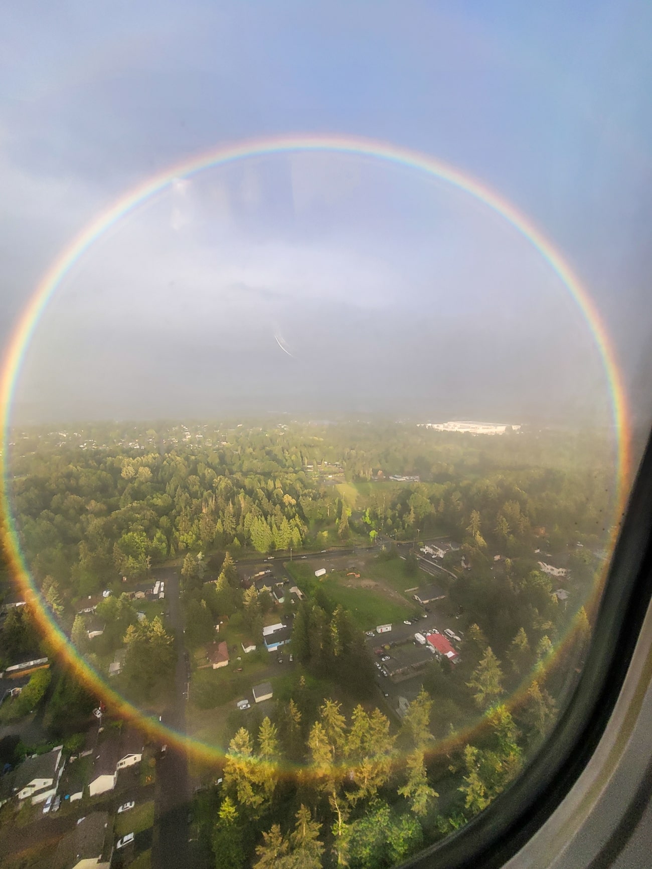 Circular rainbow captured from the window of an airplane