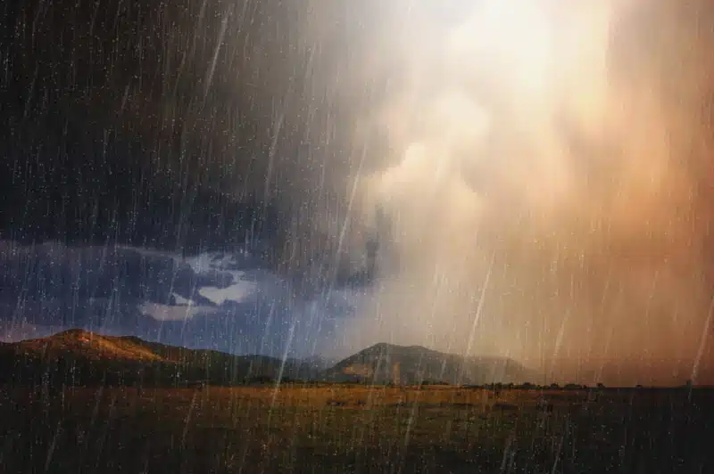 Rain falling over mountain landscape