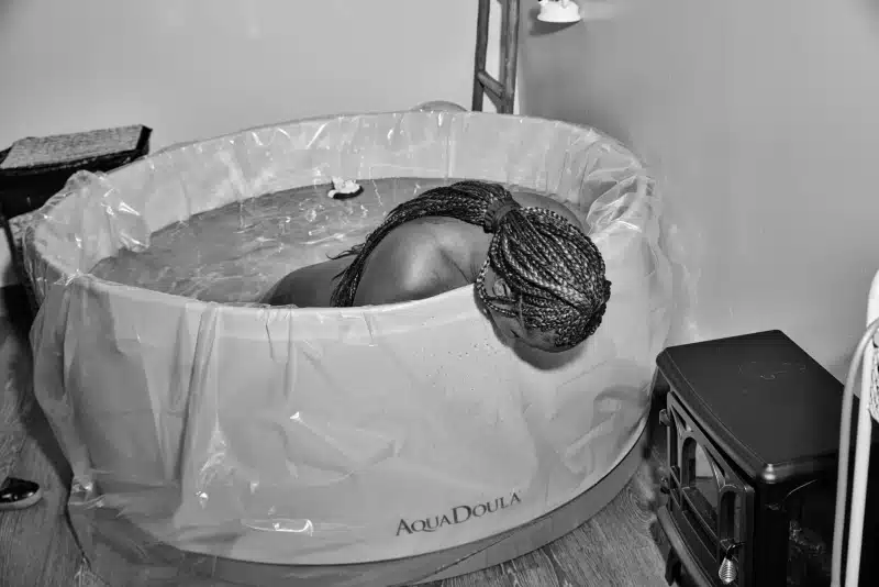 Woman during a water birth by Maggie Shannon