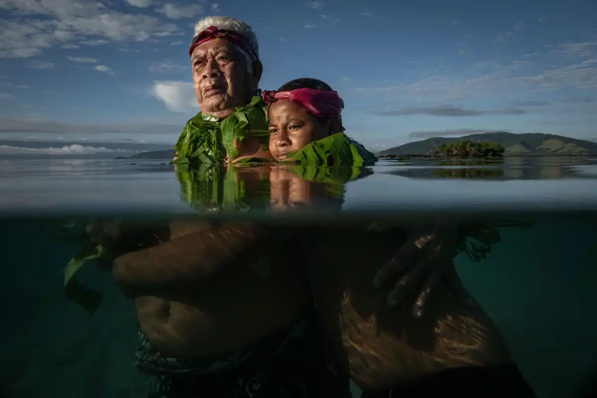 ommunity elder, stands with his grandson John at the point where he remembers the shoreline used to be when he was a boy