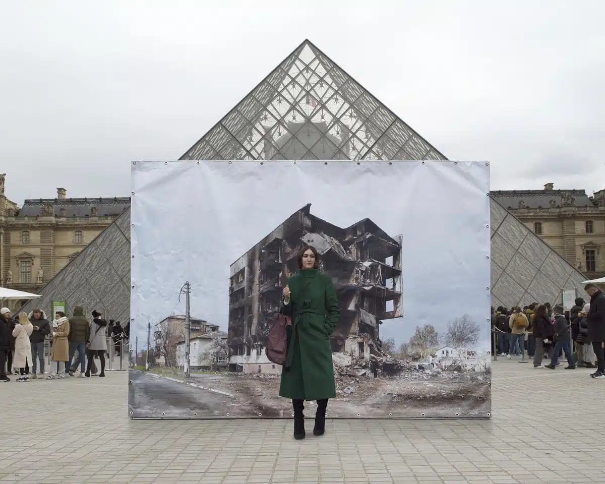 Danila Tkachenko Ukrainian girl posing in front of an image of her homeland