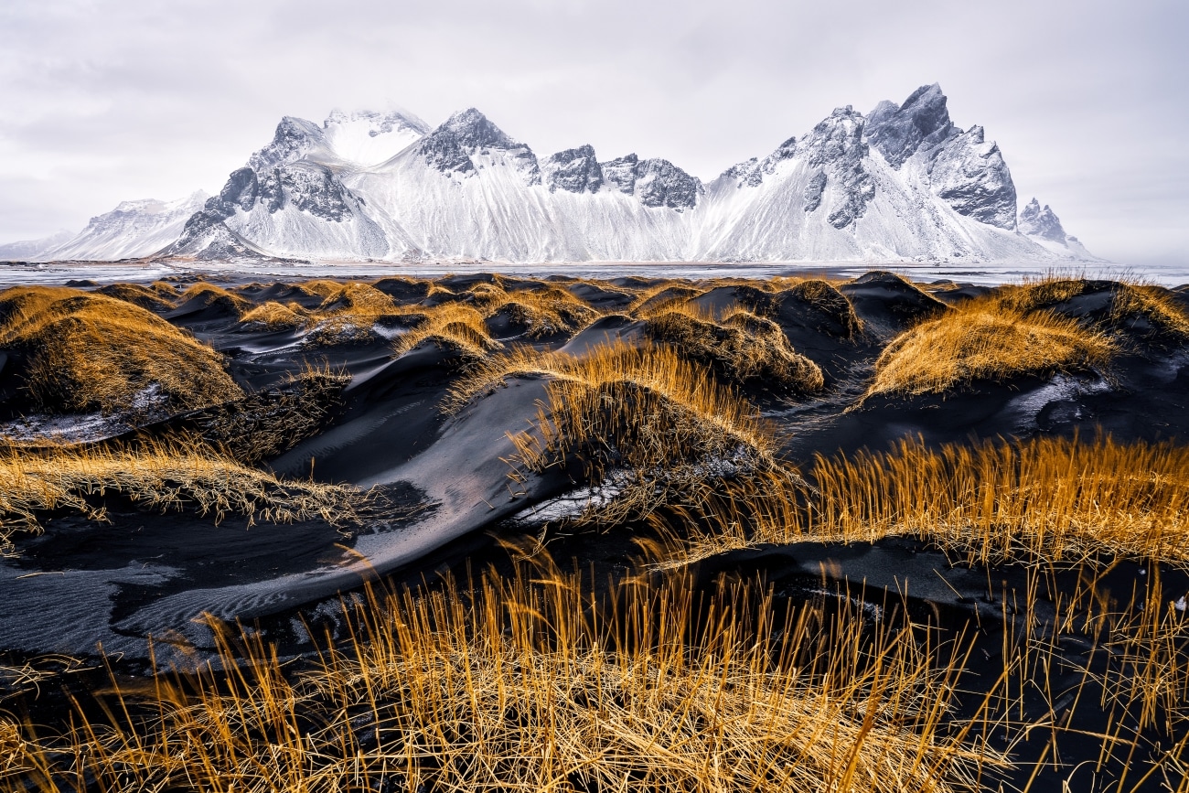 Winter landscape in Stokksnes, Iceland, on a beach with black sand and the majestic mountain called Vestrahorn.