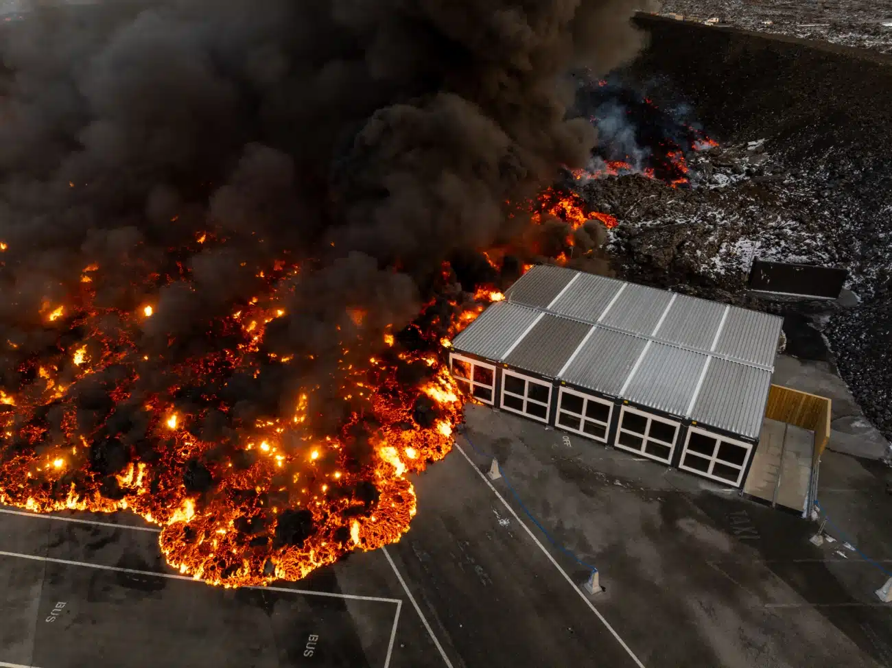 Lava running over service house on the parking lot of Blue Lagoon