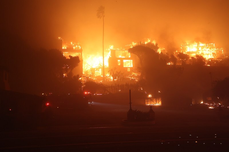 Firefighters save photo albums from a burning house in Pacific Palisades