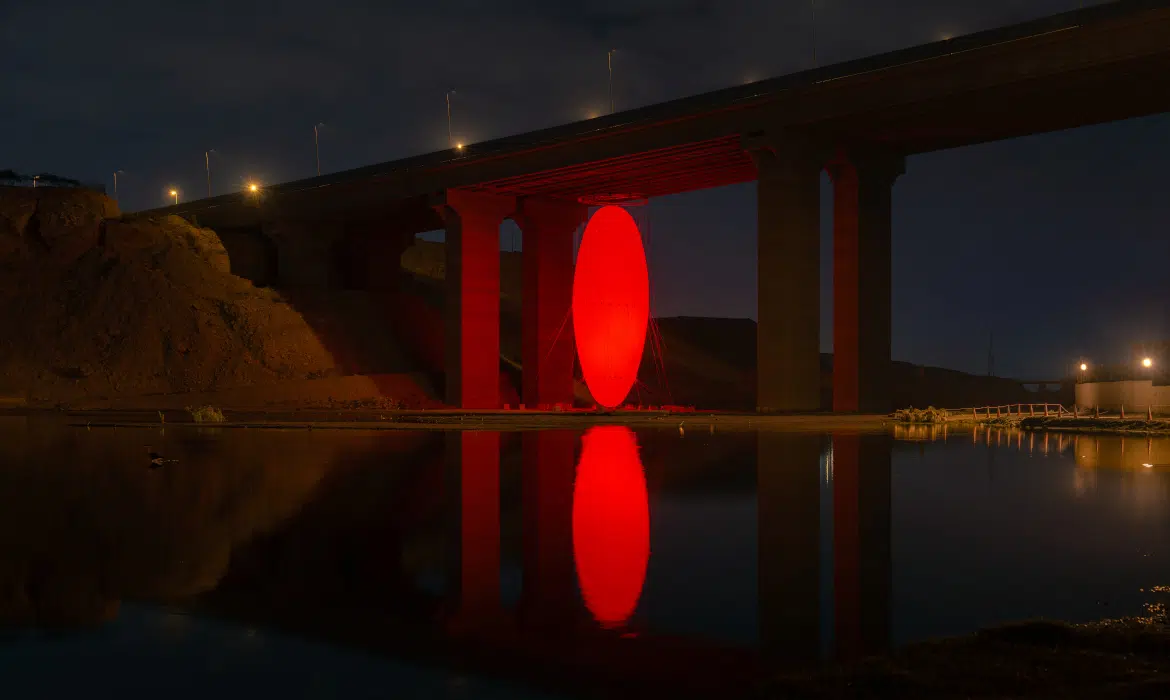 Massive Glowing Ovoid Cloaks City Streets in a Surreal Shade of Red