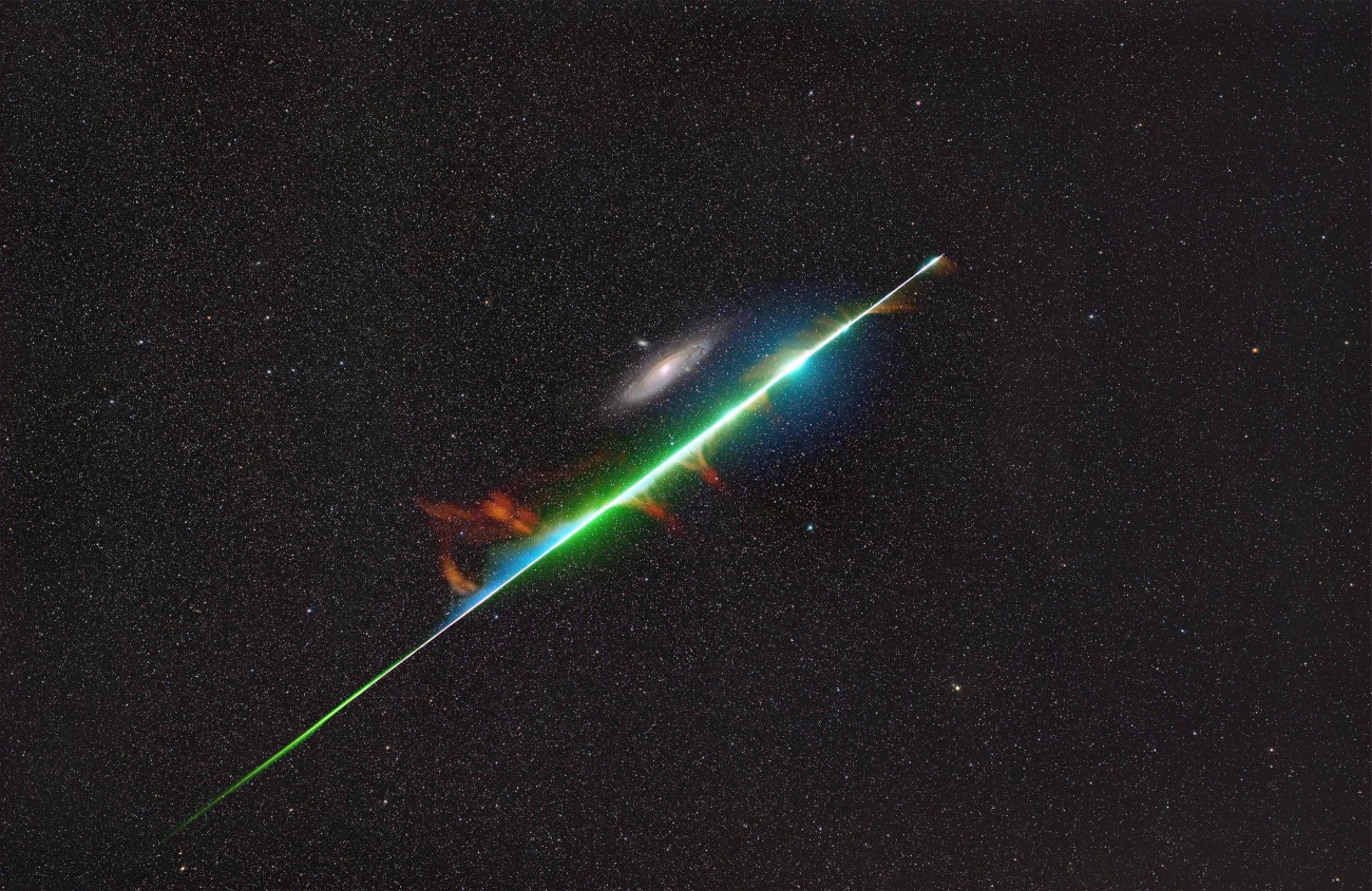 Fireball from the Perseid meteor shower appearing to graze M31, the Andromeda Galaxy.