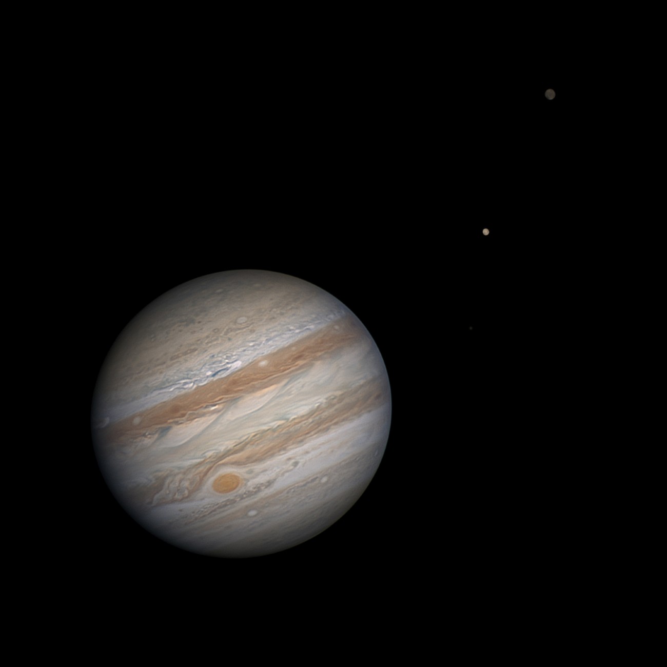 Jupiter and two of the four largest moons discovered by Galileo, Europa and Callisto