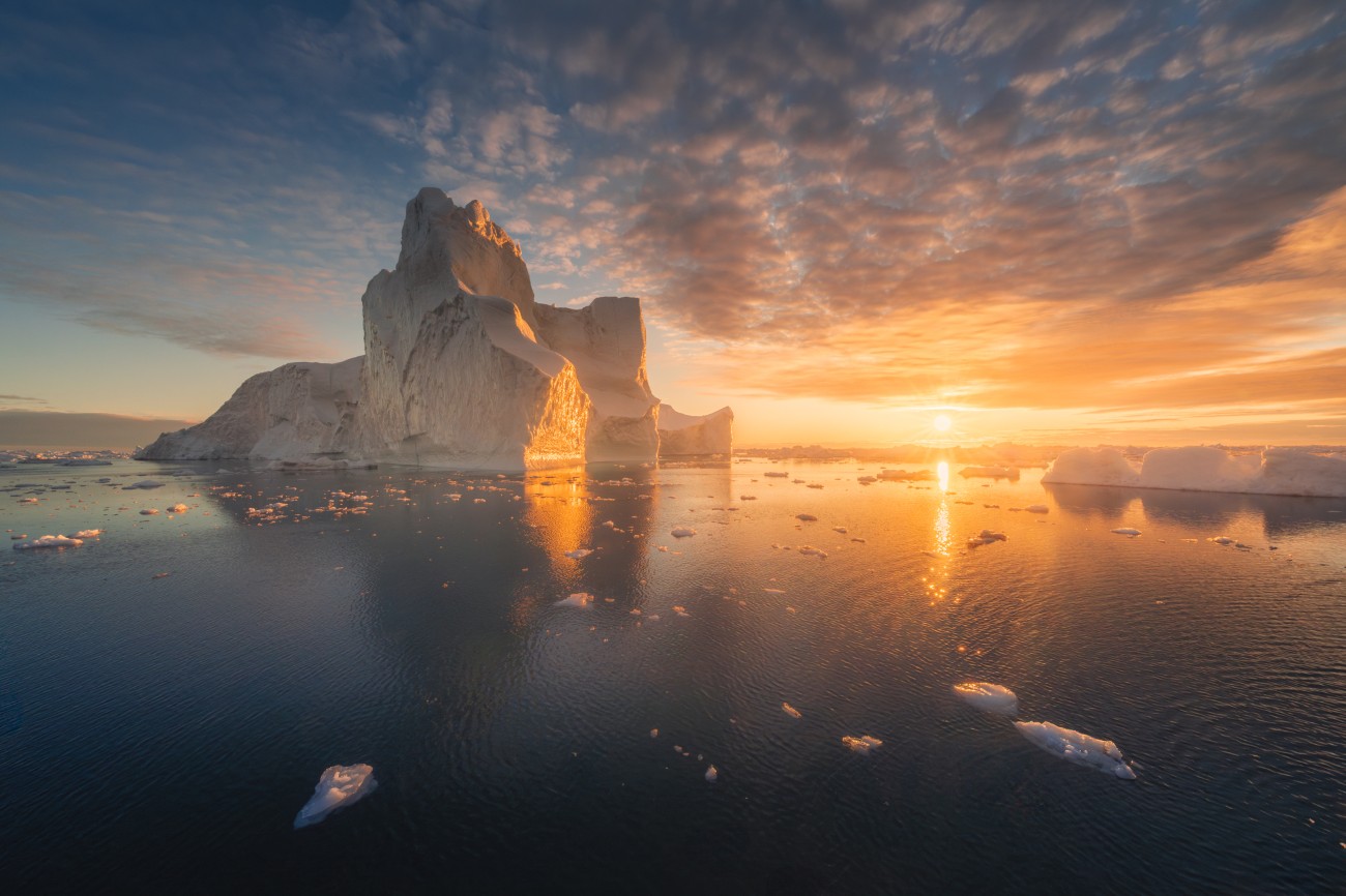 Sunset in Greenland with icebergs in the water