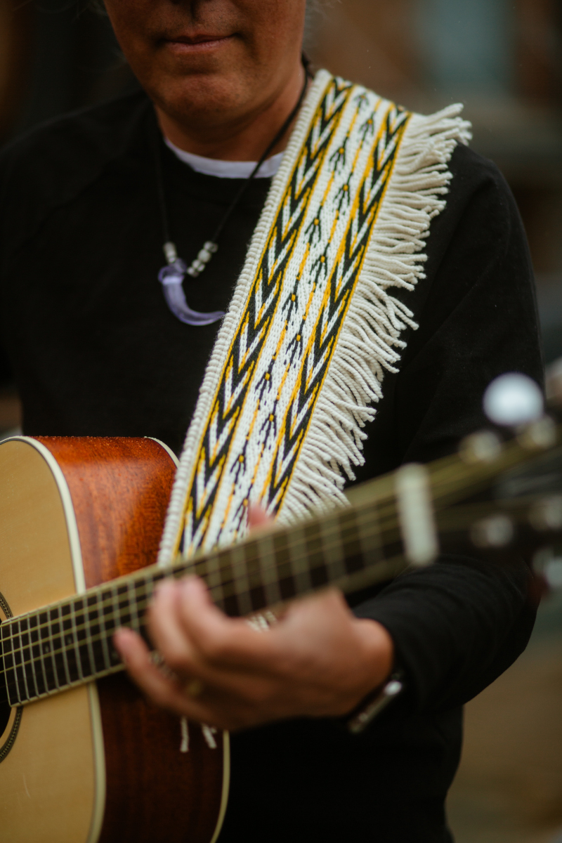 Eagle Footprints Guitar Strap, 2025 Commissioned by Preston Singletary. Ravenstail weaving techniques on thigh spun merino wool and merino weft yarns. Woven with deep honor for Lily’s mother, Clarissa Rizal. This piece crosses the boundaries of art and kinship, strengthening our connections and sharing responsibility for our community. 