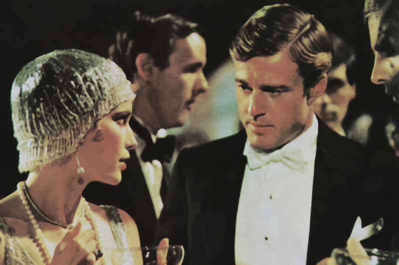 Old magazine photo of Mia Farrow and Robert Redford in The Great Gatsby from 1974 (focus on persons in front)