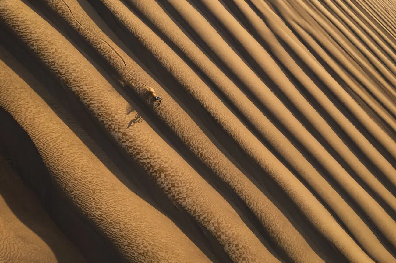 Kilian Bron riding down one of the highest sand dunes in the world