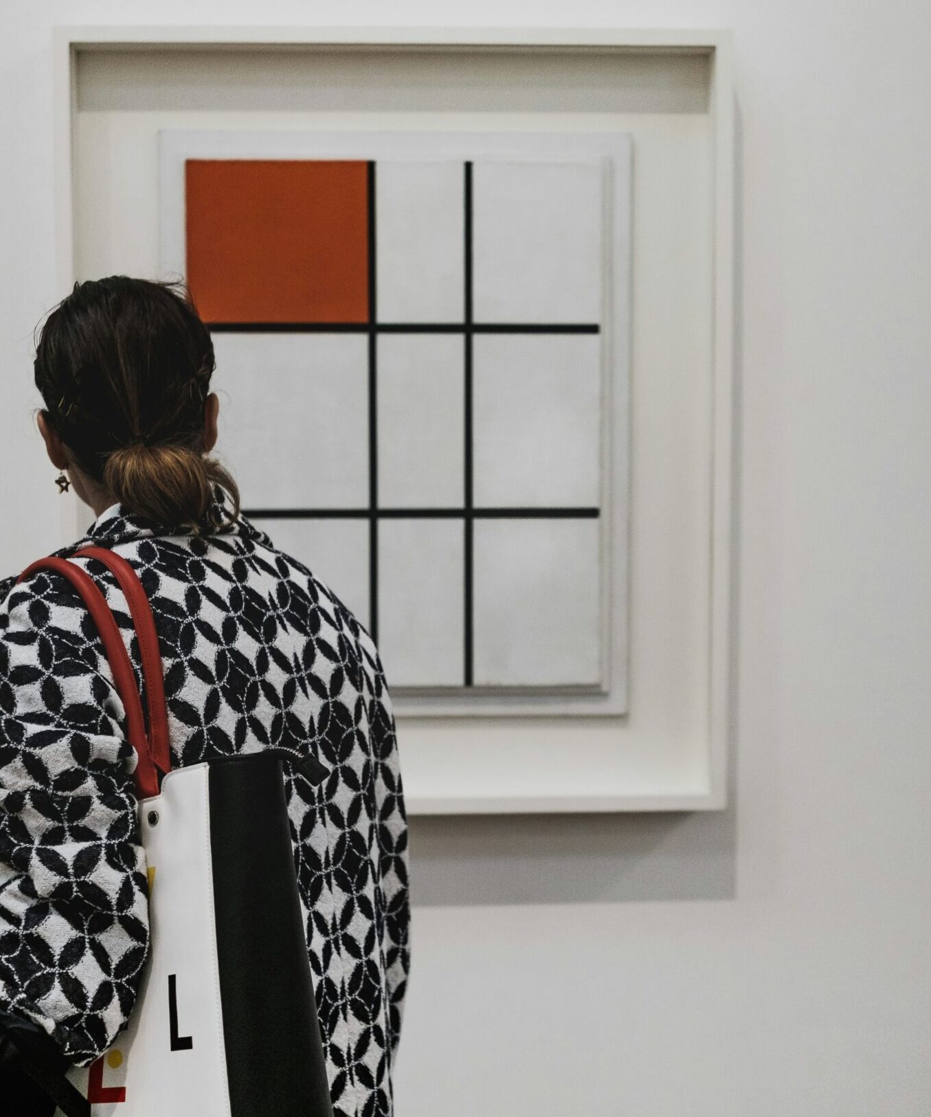 Woman looking at a Mondrian painting in a gallery