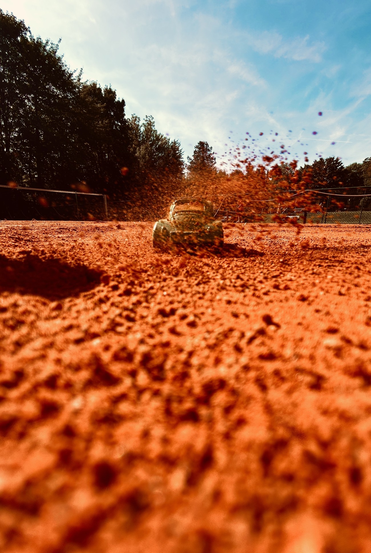 Toy car on a clay tennis court