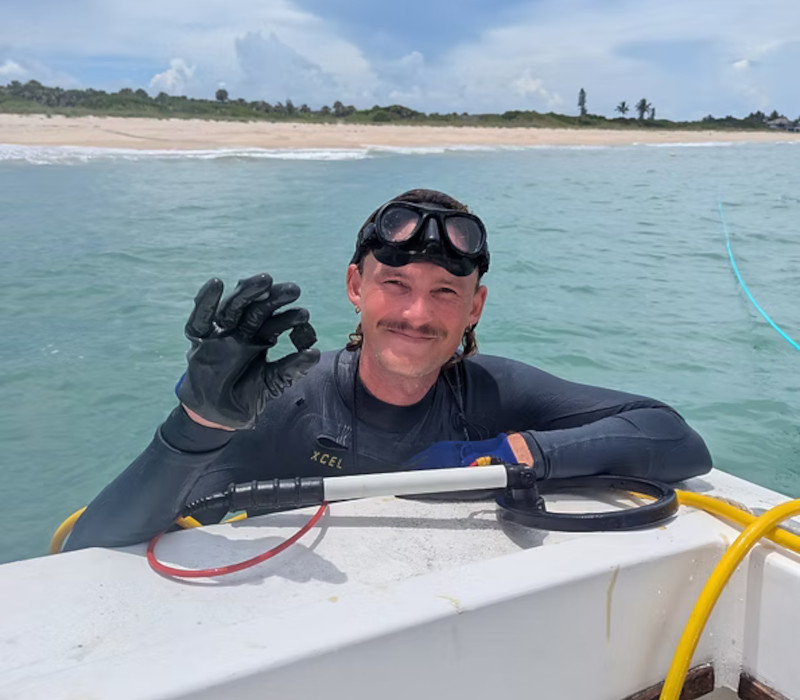 Diver holding coin