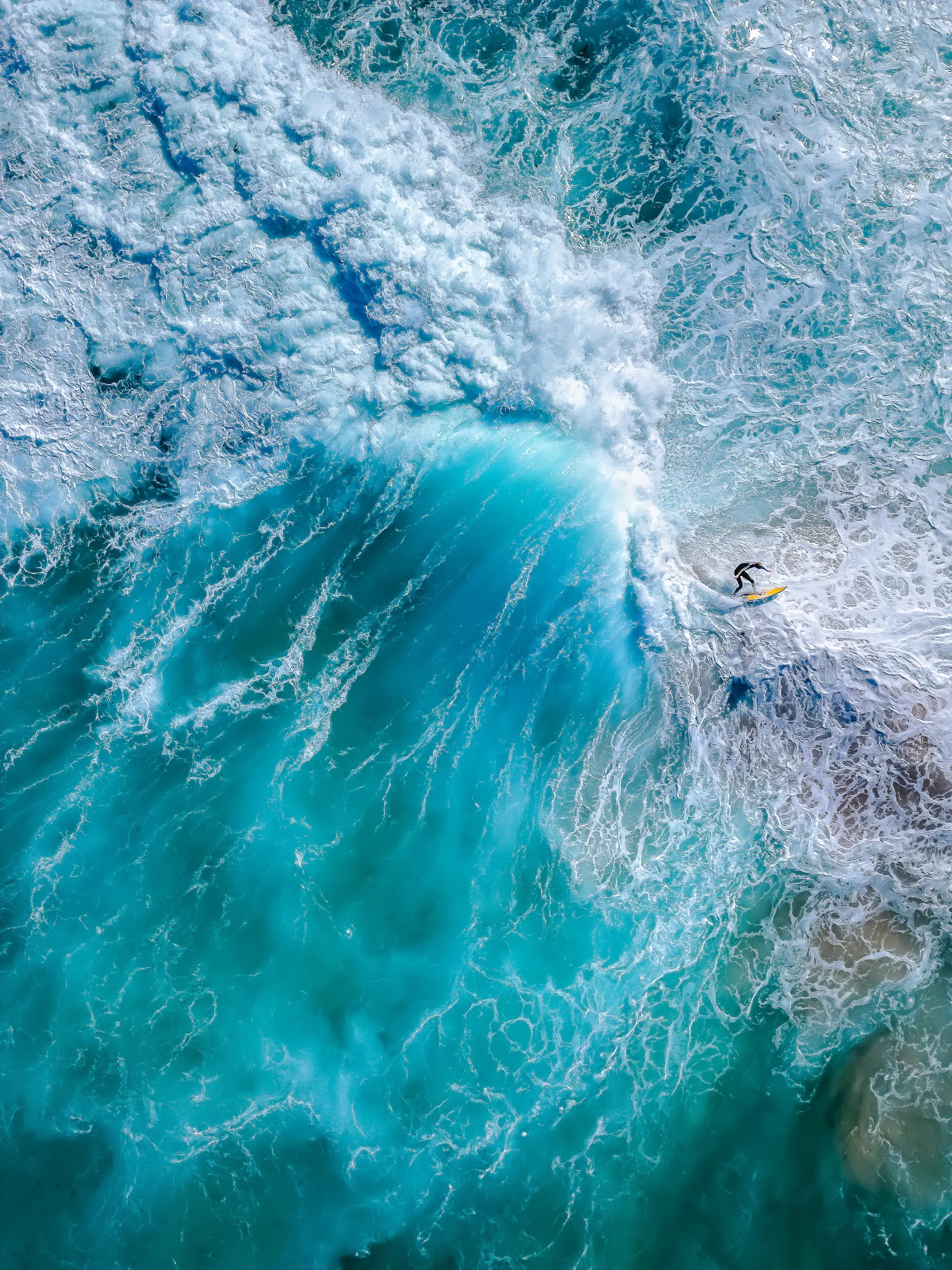 “Avalanche.” A surfer trying to outrun a mountain made of water, shot with a DJI Air 2S drone from 31 meters above.
