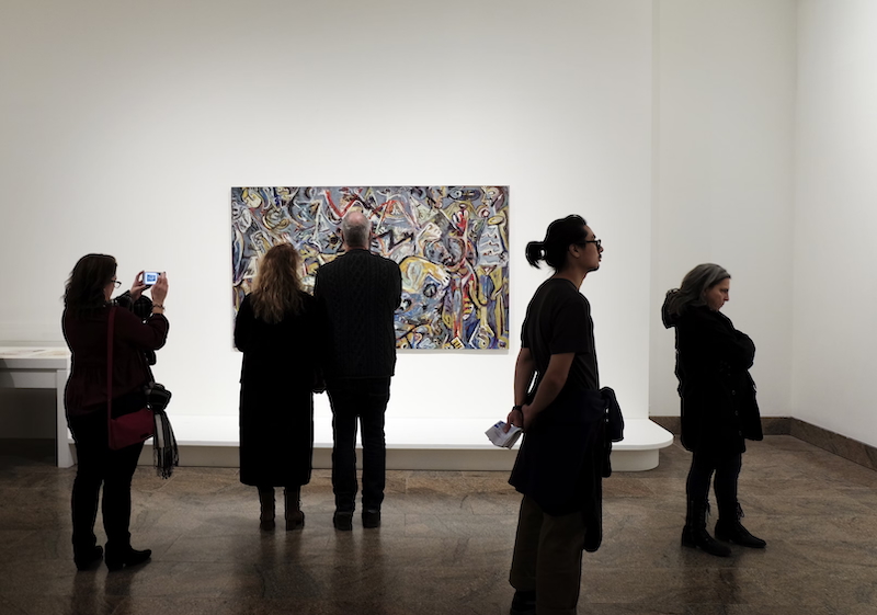 People observing art at a gallery