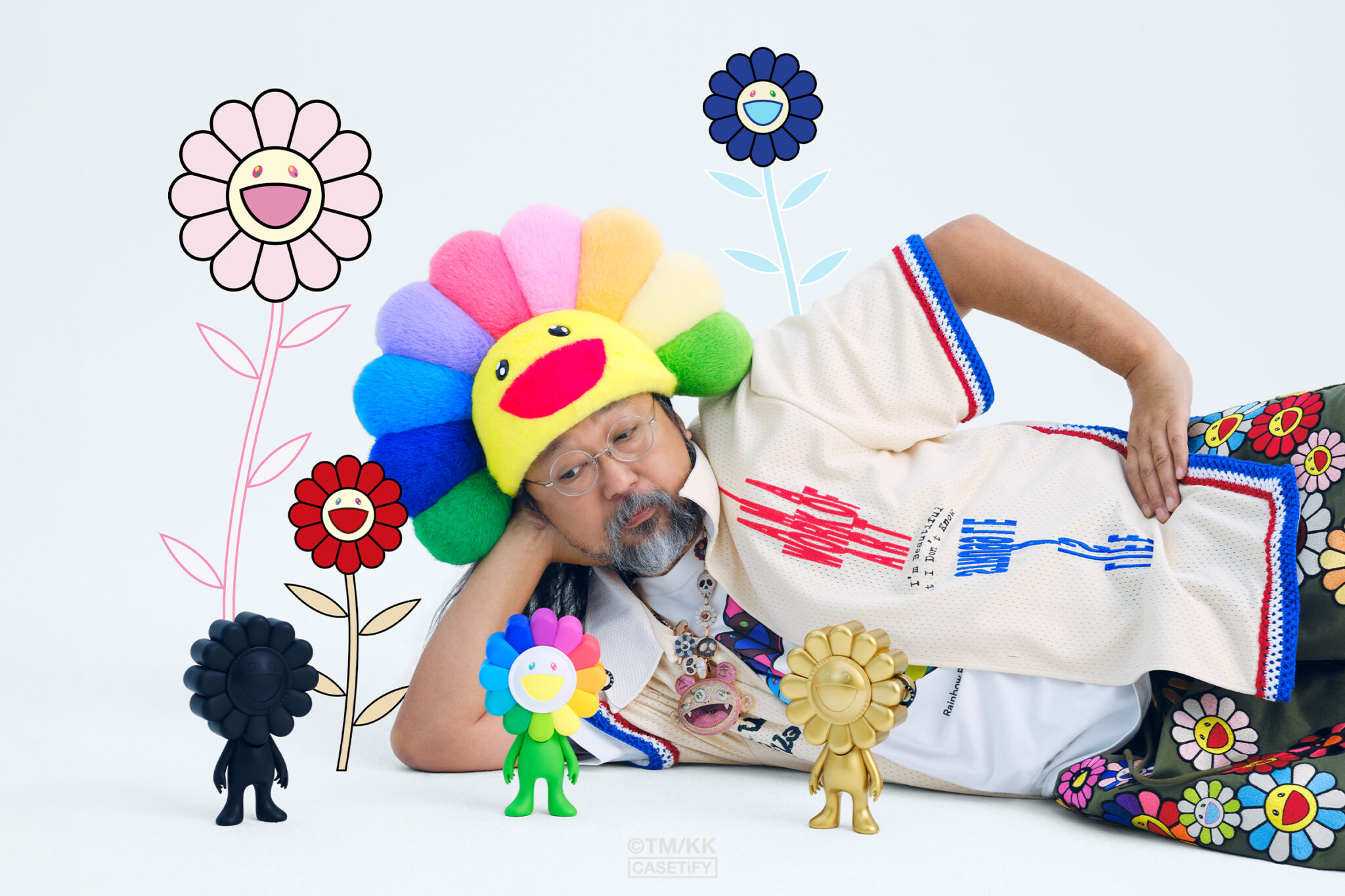 Takashi Murakami with products featured in his “Flowers Bloom” limited-edition collaboration with CASETiFY