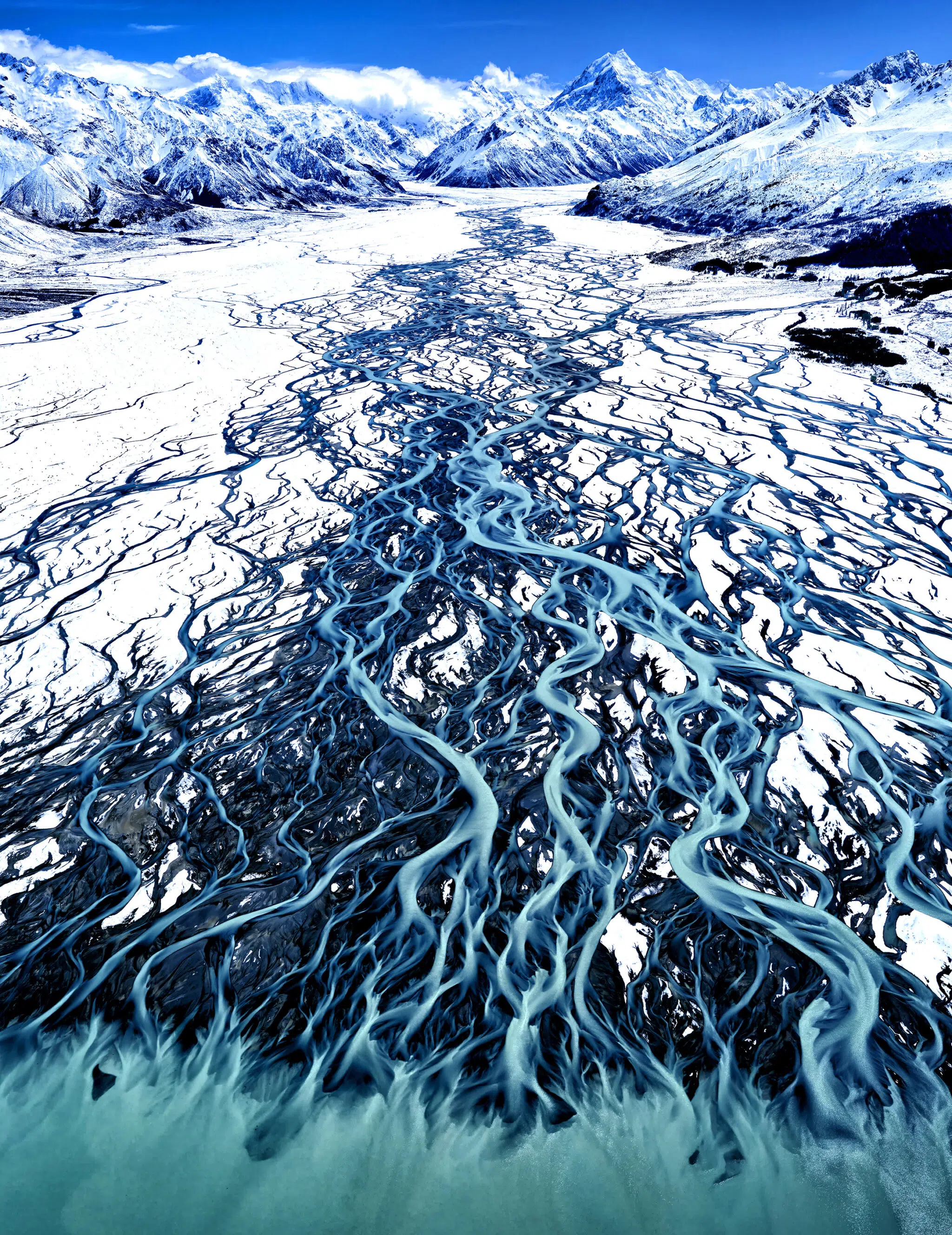 Stuart Chape, “Glacial Blue.” Gold Winner, Landscapes, Professional, in the 2025 Color Photography Contest, part of the 1839 Awards. “This series was photographed from a light aircraft and captures the blue waters of braided blue glacial rivers flowing into lakes from the high mountains of the Aoraki/Mount Cook National Park in New Zealand,” Chape says. “The blue coloration of the water is due to fine silt particles in the water.”