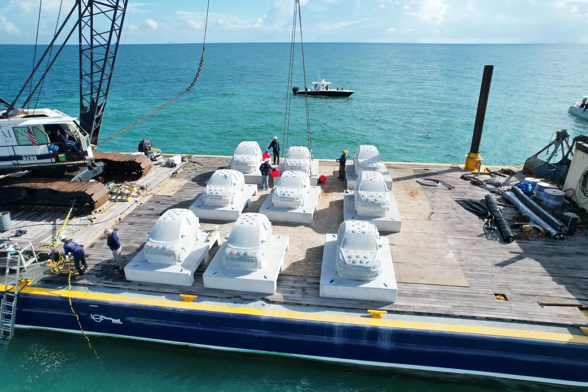 Preparing to submerge &ldquo;Concrete Coral,&rdquo; 2025, subaquatic installation featuring 22 concrete cars