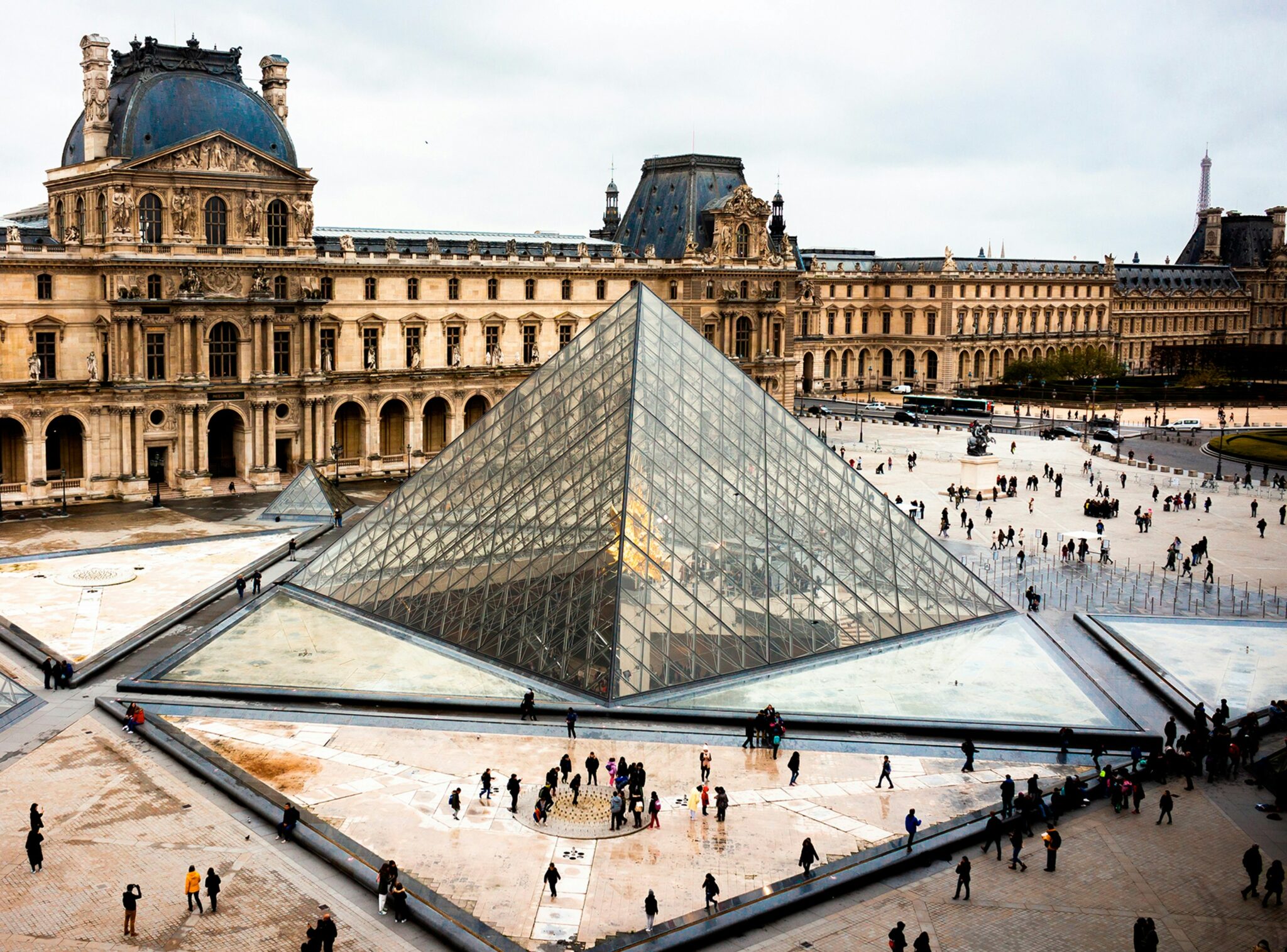 An exterior shot of the Louvre in Paris during the day
