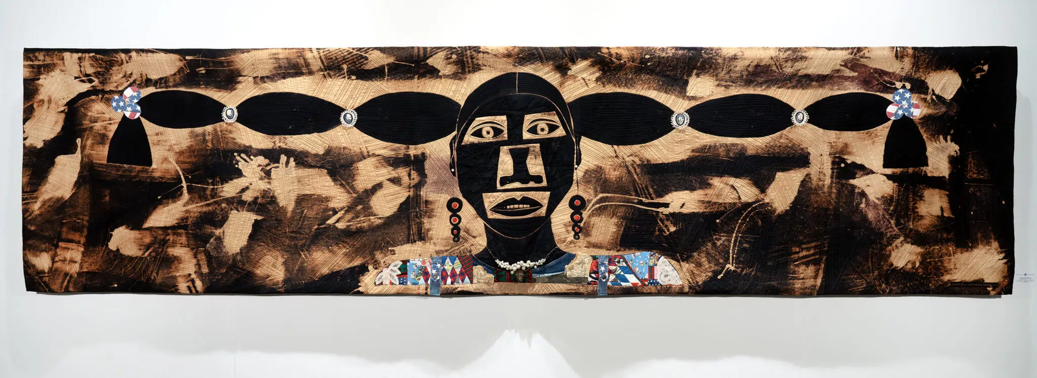 Sharon Kerry-Harlan, &lsquo;The Empire Builder,&rsquo; 2025, dye discharge, curated fabrics, quilted and embellished.